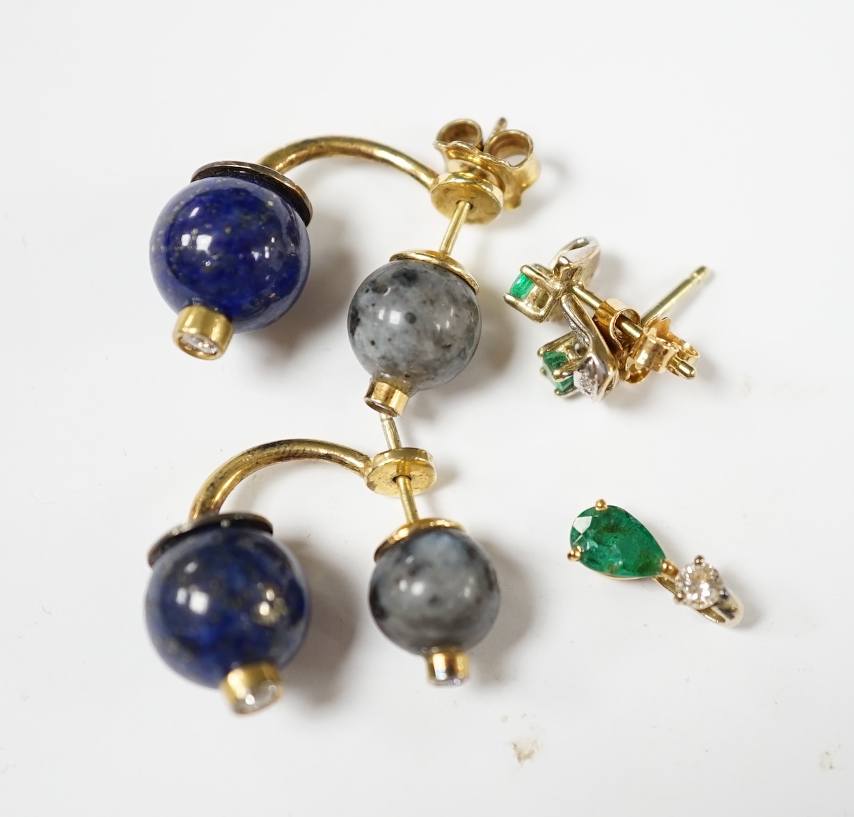 A modern small pair of yellow metal, emerald and diamond set ear studs, a similar pendant and a pair of lapis lazuli, hardstone and diamond chip set ear studs. Condition - fair